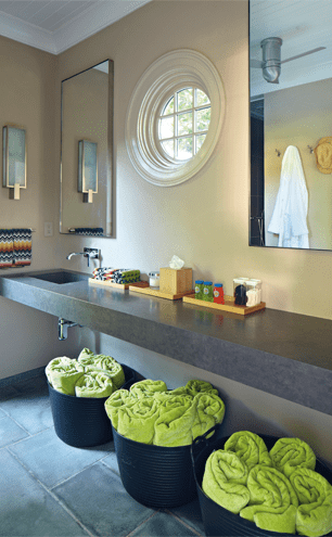 Citrus-toned towels await the bathers. Note the stone floor, carried through from the patio
