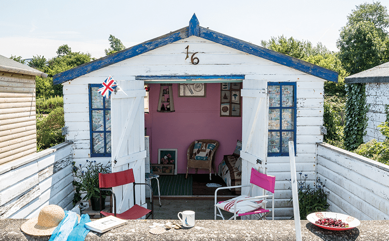The weathered tongue-and-groove is immediately evocative of the seaside. A leftover tin of pink paint came in handy for the interior