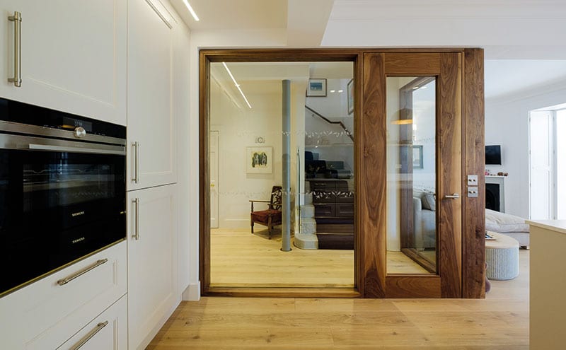 Architect Nigel Somner designed the rich walnut door and screen to allow as much light as possible through to the staircase leading to the upper floors