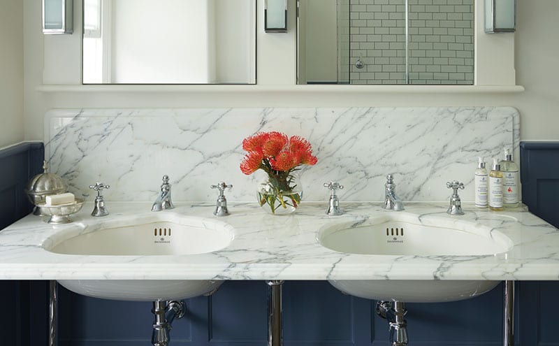A slab of Arabescato marble tops the vanity unit