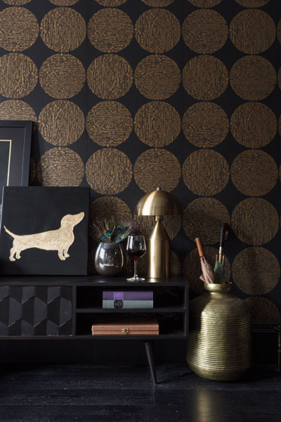 A close-up of Cole & Son’s black and gold Luna wallpaper