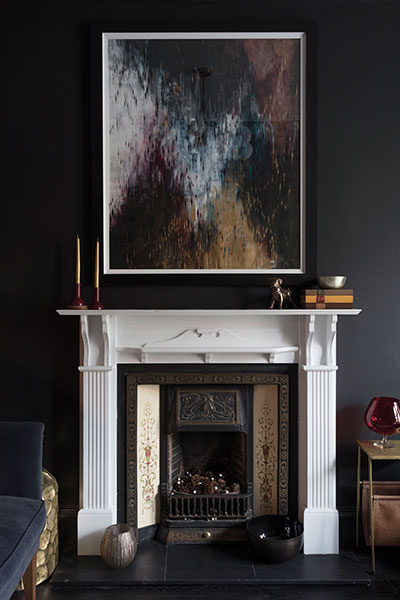 A painting by Helen Stevens hangs above the fireplace which was original to the flat