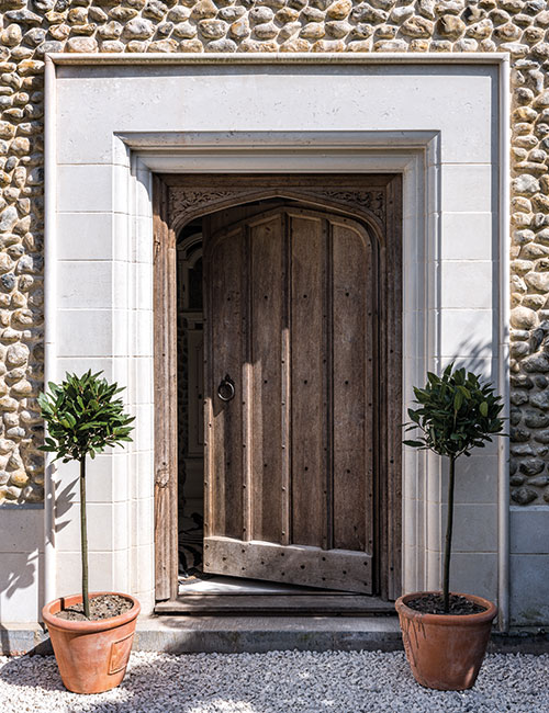 The front door is framed by a limestone surround reclaimed from a ruined 15th-century monastery