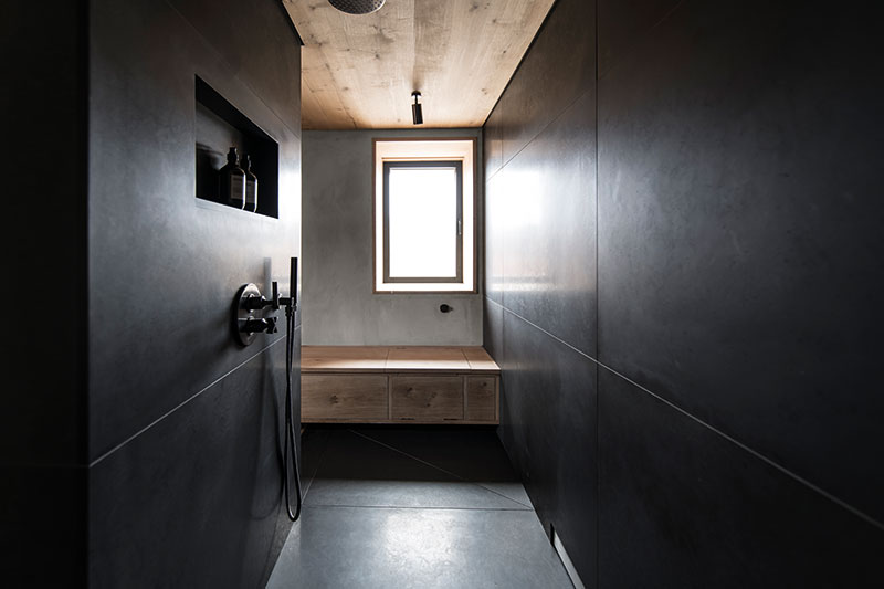 The moody walk-in shower is designed to calm the senses