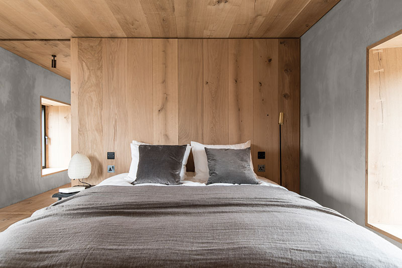 The bedroom is a stripped-back affair, with a bespoke bed built to fit the space