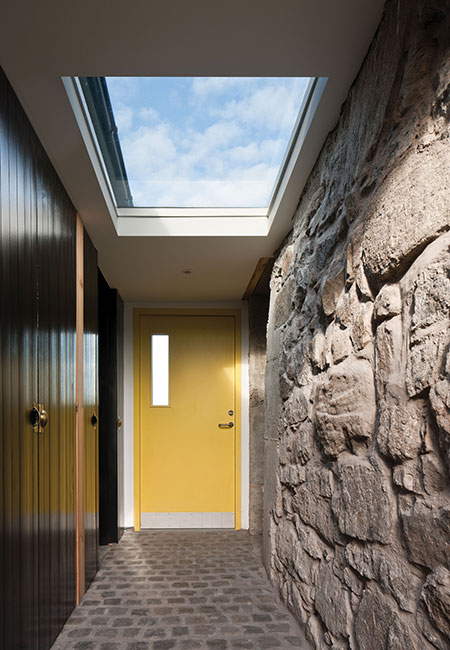 another view of the entrance hall, with its cobblestone floor and generous rooflight