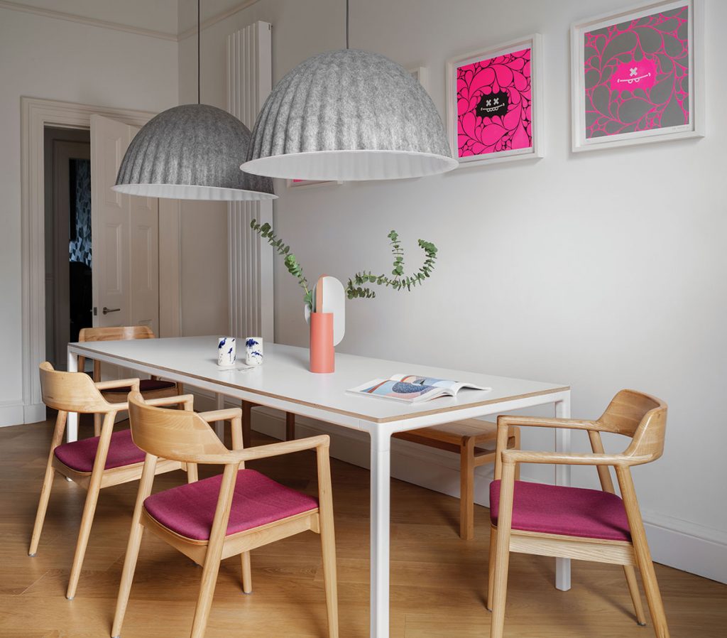 dining-room-with-wood-and-grey-lampshades-and-neon-pink-prints