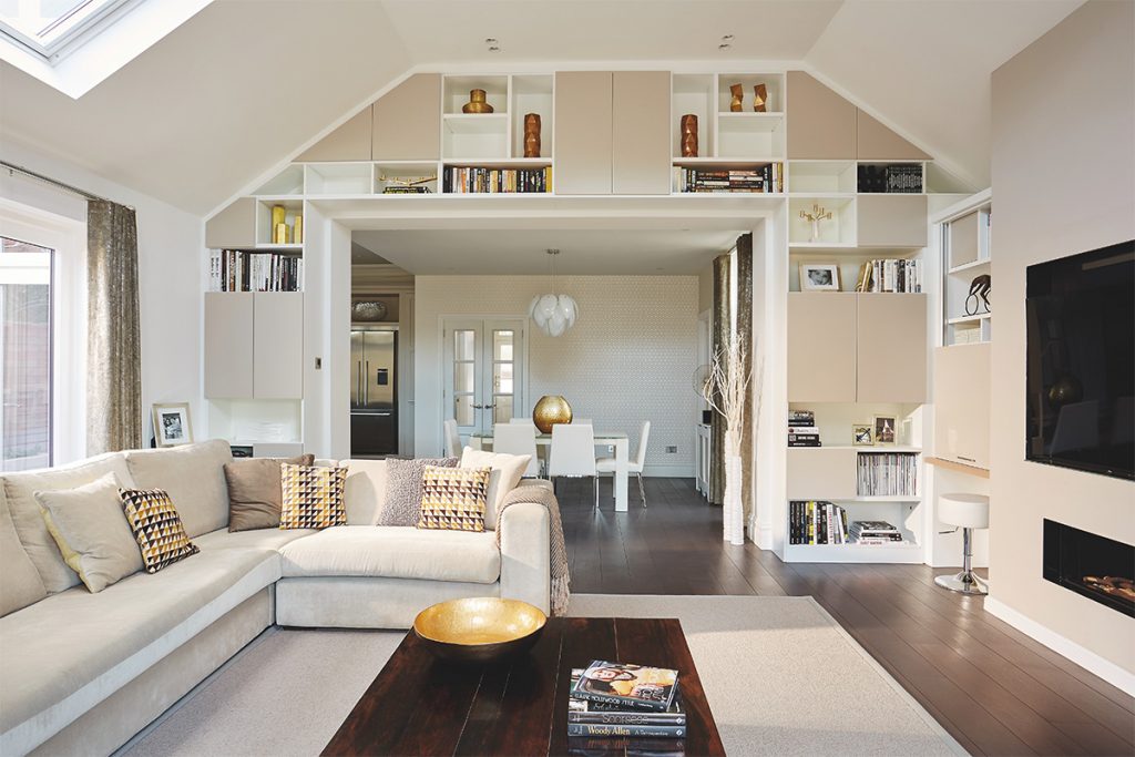 Bright white living room with large square open archway with built-in storage surround the opening