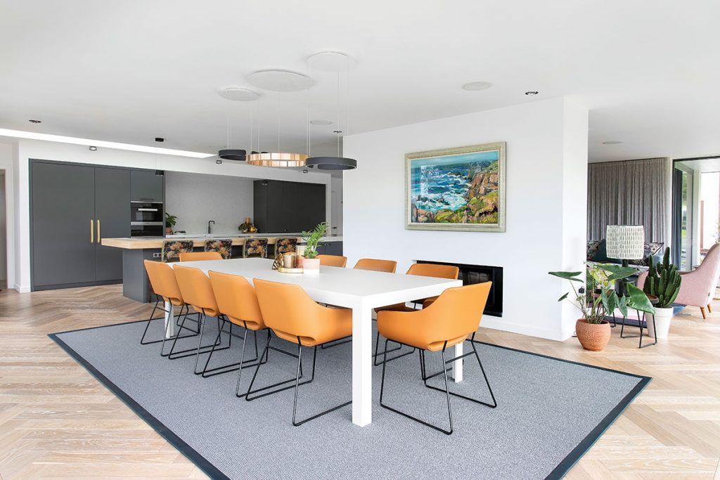 dining-area-in-open-plan-kitchen-with-orange-chairs.jpg